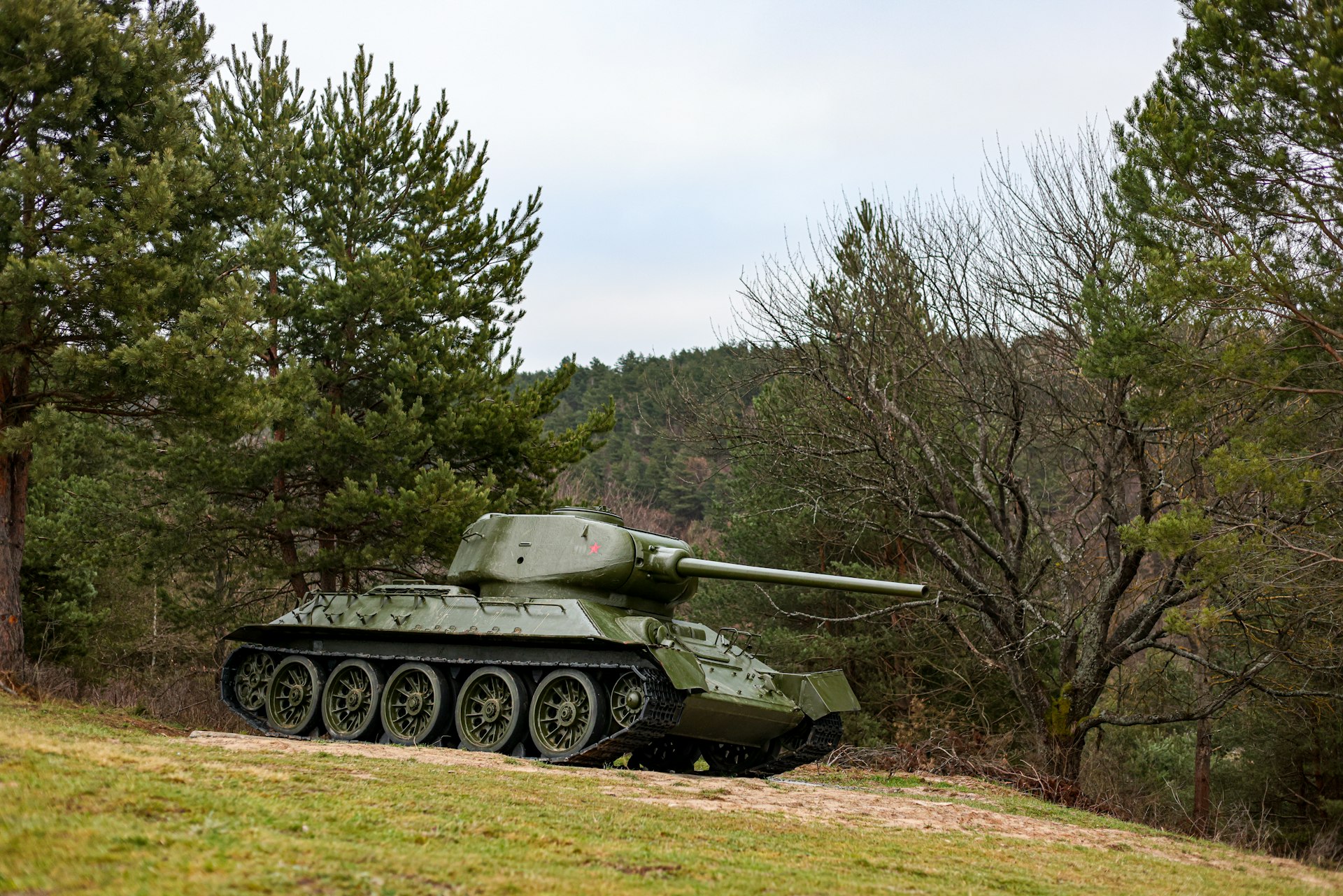 a tank is parked on a grassy hill